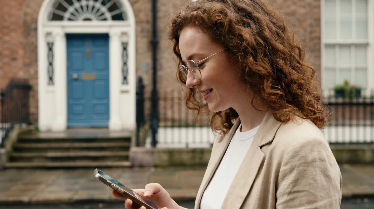 A young woman by a colourful Georgian doorway in Dublin on a soft summer day